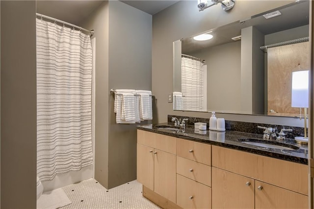 360 W Pershing Rd Unit 250, Kansas City, MO 64108 - bathroom with double vanity, tile patterned floors, and a shower with curtain