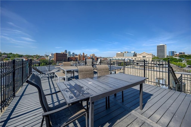 360 W Pershing Rd Unit 250, Kansas City, MO 64108 - wooden deck with a view of city and outdoor dining area