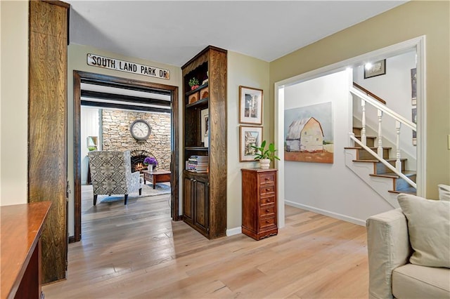 12000 Overbrook Rd, Leawood, KS 66209 - hallway featuring light wood finished floors, stairway, and baseboards