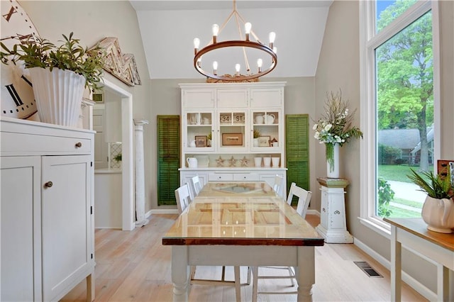 12000 Overbrook Rd, Leawood, KS 66209 - dining space featuring a chandelier, light wood-type flooring, healthy amount of natural light, and vaulted ceiling