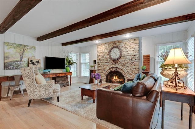 12000 Overbrook Rd, Leawood, KS 66209 - living room featuring wood finished floors, a stone fireplace, beam ceiling, and wooden walls