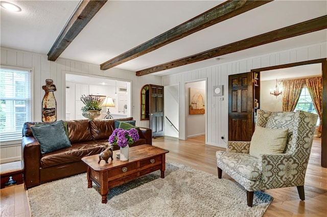 12000 Overbrook Rd, Leawood, KS 66209 - living area featuring beamed ceiling, wood finished floors, and a chandelier