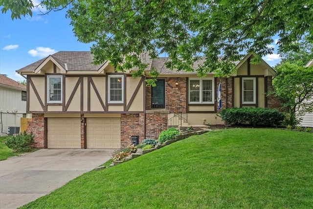 14613 S Locust St, Olathe, KS 66062 - tudor home featuring stucco siding, a front yard, driveway, an attached garage, and brick siding