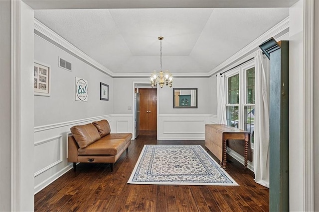 14613 S Locust St, Olathe, KS 66062 - sitting room featuring dark wood-style floors, a chandelier, wainscoting, ornamental molding, and a raised ceiling