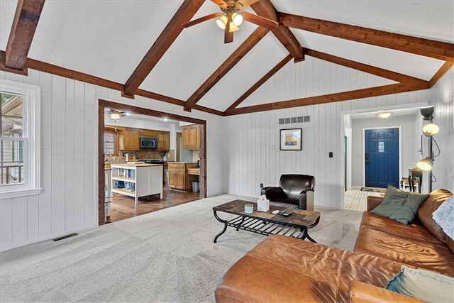 14613 S Locust St, Olathe, KS 66062 - living room with ceiling fan, dark colored carpet, and wood walls