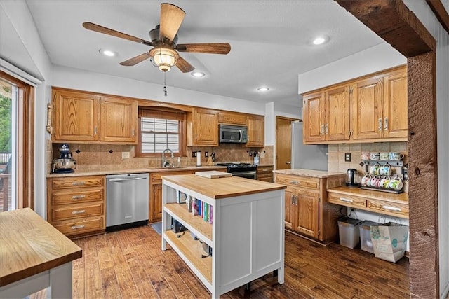 14613 S Locust St, Olathe, KS 66062 - kitchen featuring appliances with stainless steel finishes, butcher block counters, plenty of natural light, decorative backsplash, and recessed lighting