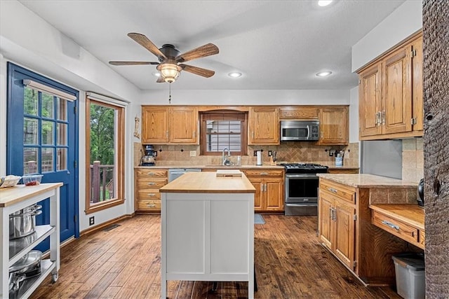 14613 S Locust St, Olathe, KS 66062 - kitchen featuring stainless steel appliances, butcher block counters, ceiling fan, backsplash, and recessed lighting