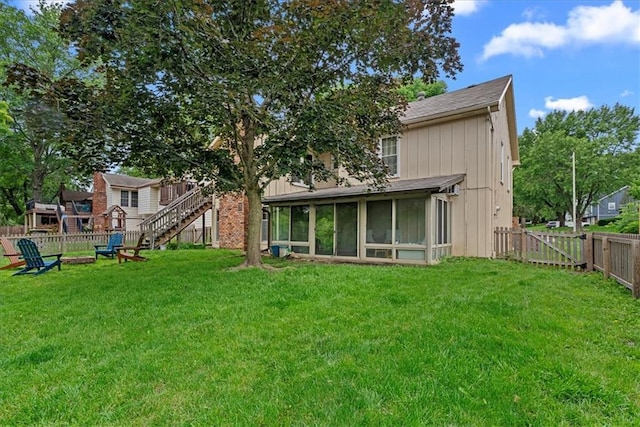14613 S Locust St, Olathe, KS 66062 - rear view of house featuring a sunroom, a fenced backyard, stairway, and a shingled roof