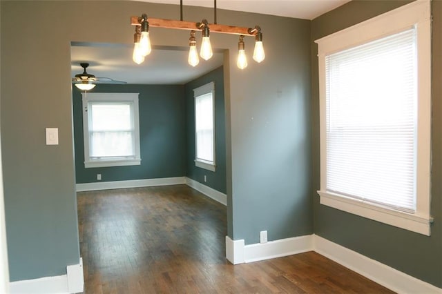 816 S Huttig Ave, Independence, MO 64053 - empty room featuring dark wood-style flooring, a ceiling fan, and baseboards