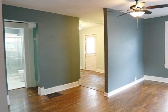816 S Huttig Ave, Independence, MO 64053 - unfurnished room featuring ceiling fan, wood finished floors, and baseboards