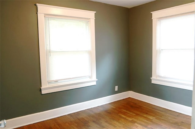 816 S Huttig Ave, Independence, MO 64053 - spare room featuring baseboards and wood finished floors