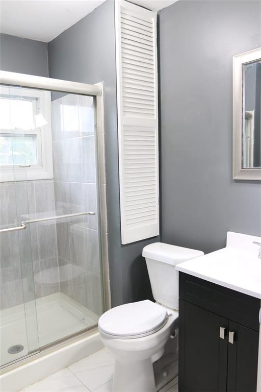 816 S Huttig Ave, Independence, MO 64053 - full bathroom with vanity, toilet, and a shower stall