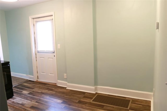 816 S Huttig Ave, Independence, MO 64053 - unfurnished room featuring dark wood-style flooring and baseboards