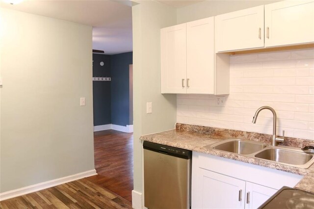 816 S Huttig Ave, Independence, MO 64053 - kitchen featuring dishwasher, a sink, dark wood-style flooring, baseboards, and decorative backsplash