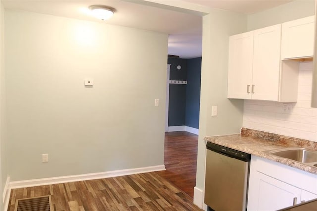 816 S Huttig Ave, Independence, MO 64053 - kitchen featuring stainless steel dishwasher, dark wood finished floors, baseboards, white cabinetry, and light countertops