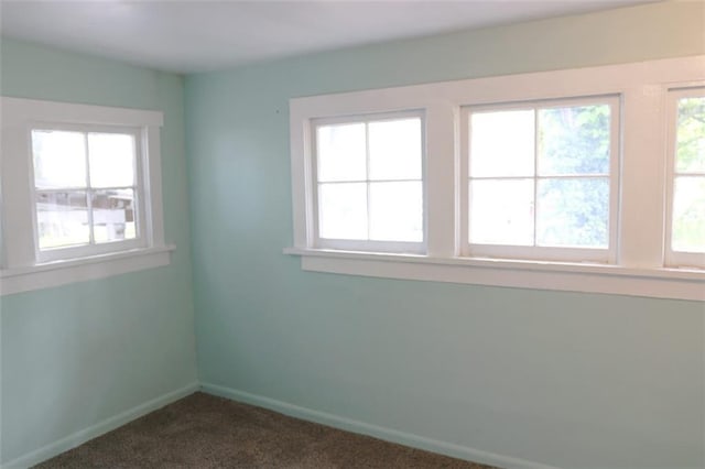 816 S Huttig Ave, Independence, MO 64053 - unfurnished room featuring dark carpet and baseboards