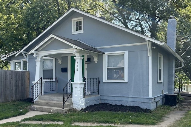 816 S Huttig Ave, Independence, MO 64053 - bungalow featuring a chimney, central AC, and a porch