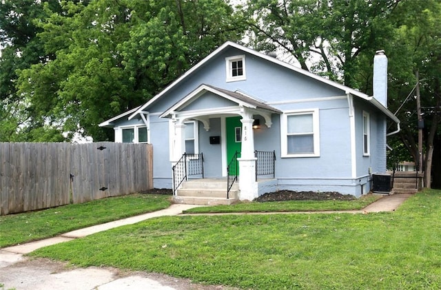 816 S Huttig Ave, Independence, MO 64053 - bungalow-style home with a chimney, a porch, and cooling unit