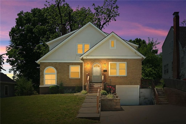 314 N Crysler Ave, Independence, MO 64050 - traditional-style house with brick siding, a garage, stucco siding, stairs, and concrete driveway