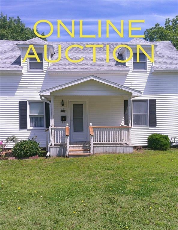 220 W State St, Erie, KS 66733 - view of front of property featuring a front lawn, a porch, and roof with shingles