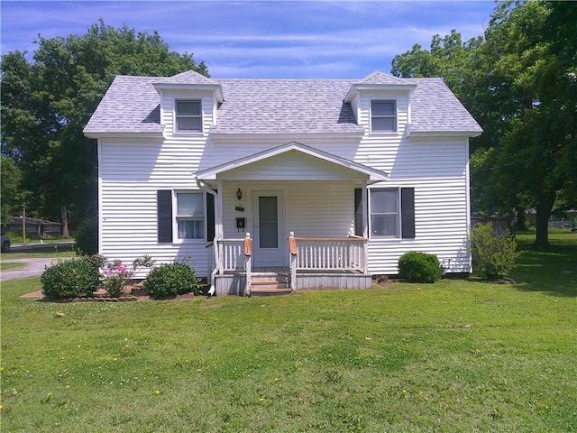 220 W State St, Erie, KS 66733 - view of front of house with a porch, a front yard, and a shingled roof