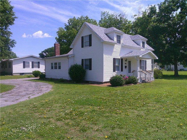 220 W State St, Erie, KS 66733 - view of front of property featuring a porch, a front yard, a chimney, and a shingled roof