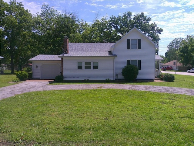 220 W State St, Erie, KS 66733 - traditional home featuring driveway, a front yard, a garage, a chimney, and a shingled roof