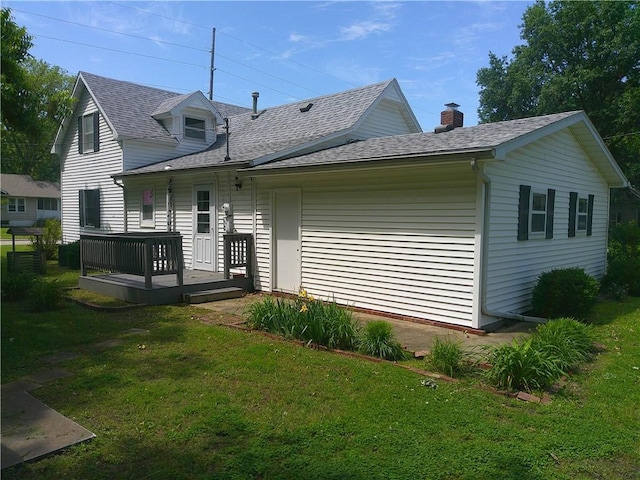 220 W State St, Erie, KS 66733 - back of property featuring a yard and roof with shingles
