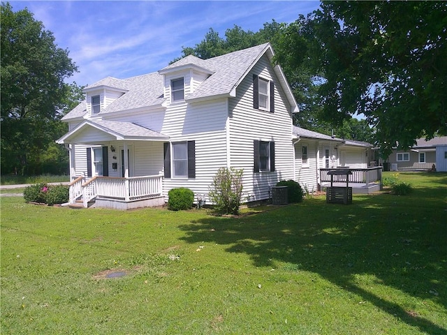 220 W State St, Erie, KS 66733 - view of front of home with a porch, a shingled roof, and a front lawn