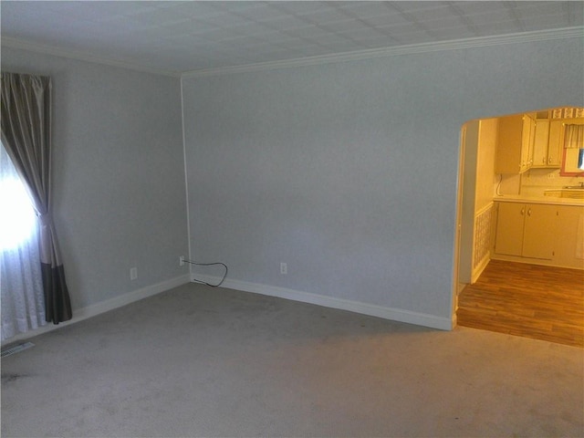 220 W State St, Erie, KS 66733 - carpeted spare room with crown molding and baseboards