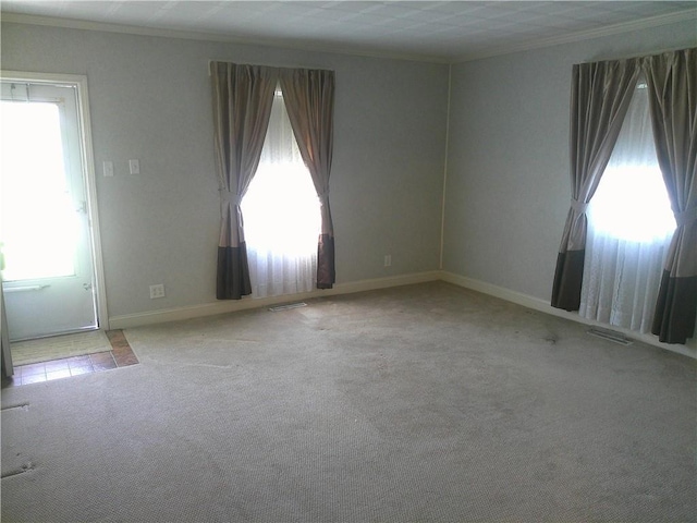 220 W State St, Erie, KS 66733 - unfurnished room with healthy amount of natural light, carpet floors, baseboards, and ornamental molding