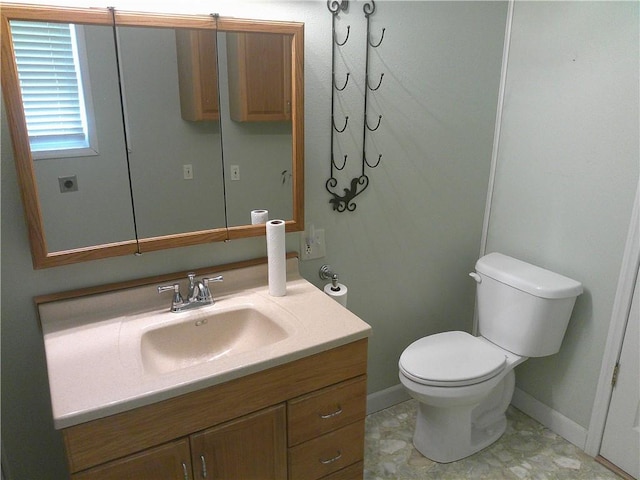 220 W State St, Erie, KS 66733 - half bathroom with vanity, toilet, and baseboards