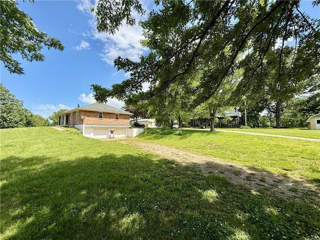 450 SW 725th Rd, Chilhowee, MO 64733 - view of grassy yard featuring driveway and an attached garage
