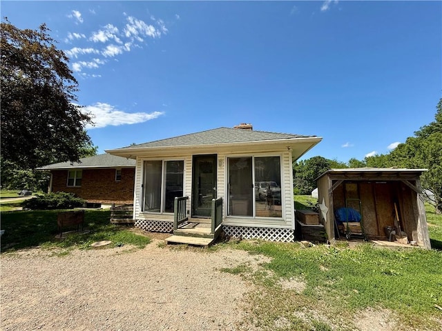 450 SW 725th Rd, Chilhowee, MO 64733 - back of house featuring a chimney and a sunroom