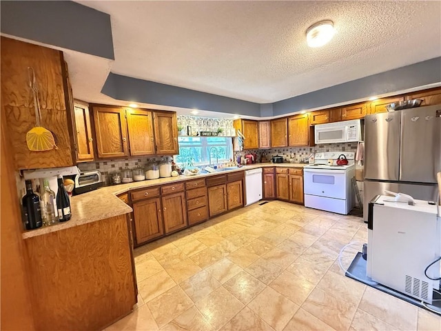 450 SW 725th Rd, Chilhowee, MO 64733 - kitchen featuring white appliances, brown cabinetry, tasteful backsplash, light countertops, and a textured ceiling