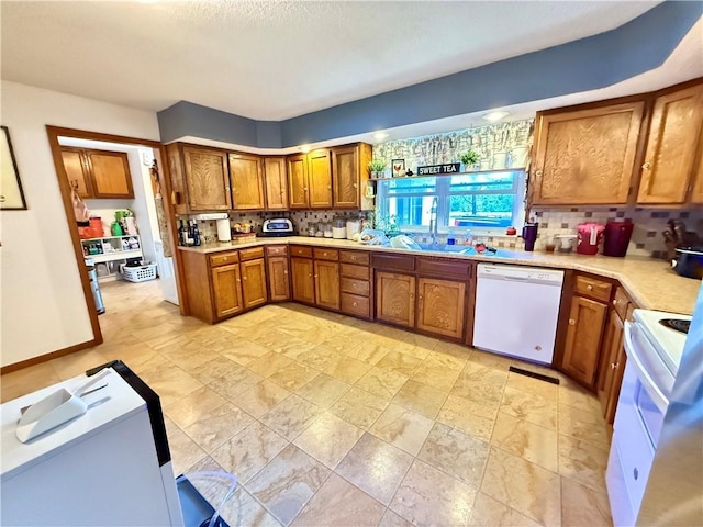 450 SW 725th Rd, Chilhowee, MO 64733 - kitchen with white appliances, brown cabinetry, tasteful backsplash, and light countertops