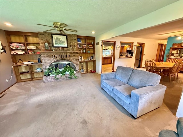 450 SW 725th Rd, Chilhowee, MO 64733 - carpeted living area featuring a ceiling fan, a brick fireplace, built in features, and a textured ceiling