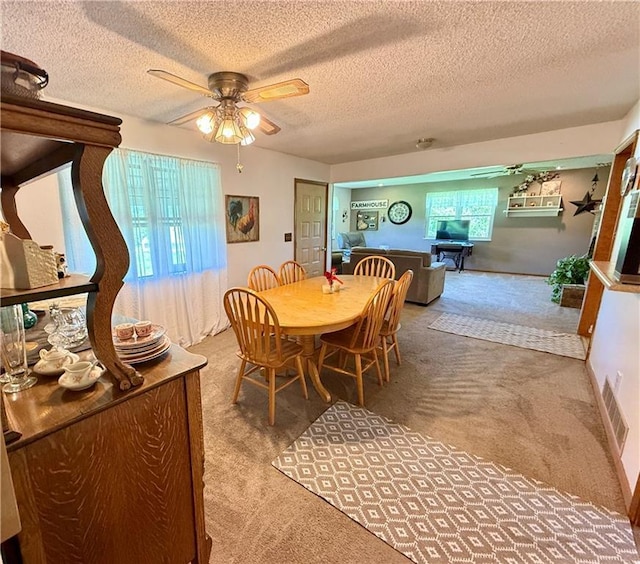450 SW 725th Rd, Chilhowee, MO 64733 - dining space with carpet floors, a textured ceiling, and ceiling fan