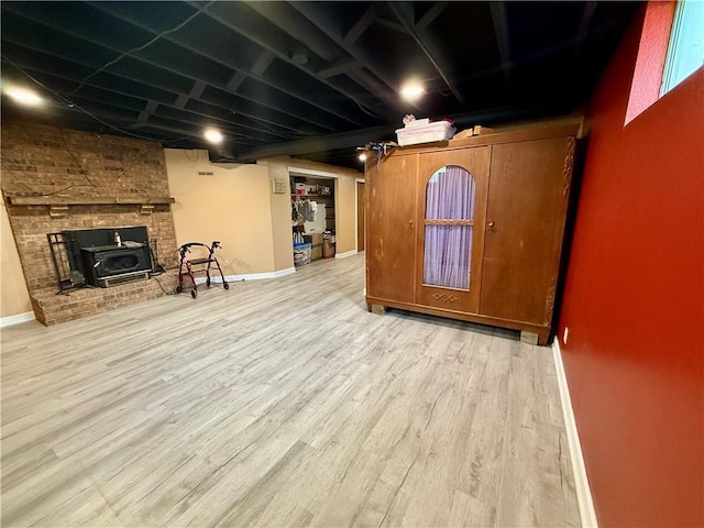 450 SW 725th Rd, Chilhowee, MO 64733 - below grade area featuring wood finished floors, baseboards, and a wood stove