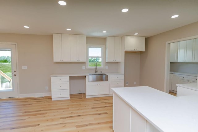 22102 E 291st St, Harrisonville, MO 64701 - kitchen with a sink, light wood-style flooring, recessed lighting, white cabinetry, and baseboards