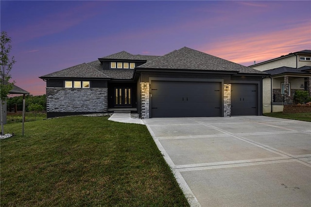8316 NW 90th St, Kansas City, MO 64153 - prairie-style home featuring a garage, driveway, a lawn, stone siding, and a shingled roof