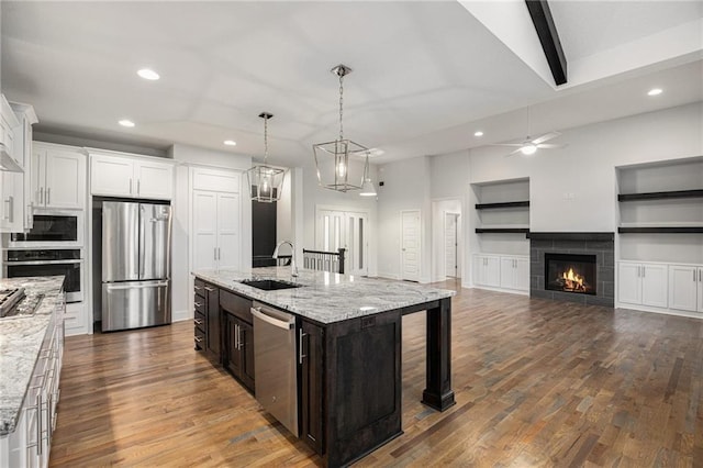 8316 NW 90th St, Kansas City, MO 64153 - kitchen featuring stainless steel appliances, a sink, recessed lighting, white cabinets, and dark wood-style floors