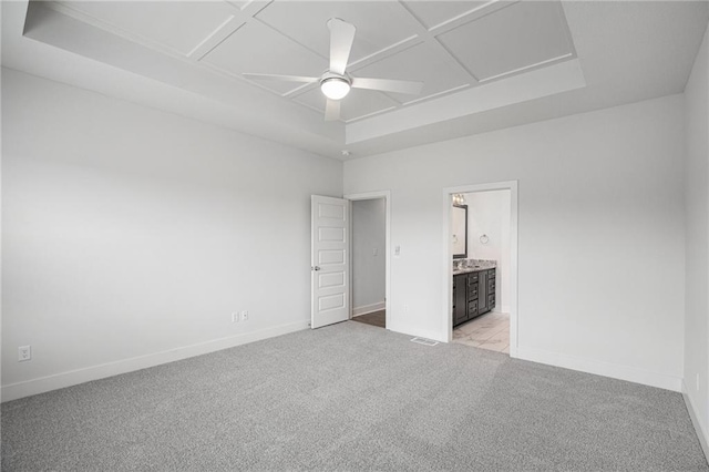 8316 NW 90th St, Kansas City, MO 64153 - unfurnished bedroom with light carpet, baseboards, ensuite bathroom, and a raised ceiling