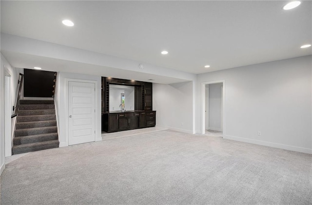 8316 NW 90th St, Kansas City, MO 64153 - finished below grade area with light colored carpet, baseboards, recessed lighting, stairway, and bar area