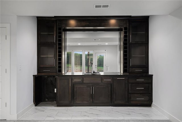 8316 NW 90th St, Kansas City, MO 64153 - bar featuring light marble finish floors, a sink, and baseboards