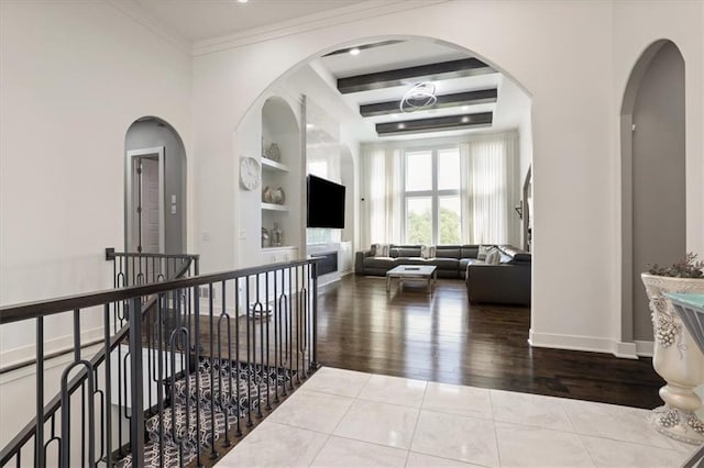 8605 NE Shl Creek Pkwy, Kansas City, MO 64157 - hallway with built in shelves, wood finished floors, baseboards, an upstairs landing, and arched walkways