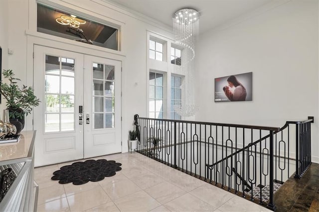 8605 NE Shl Creek Pkwy, Kansas City, MO 64157 - tiled foyer with french doors, a chandelier, healthy amount of natural light, and crown molding