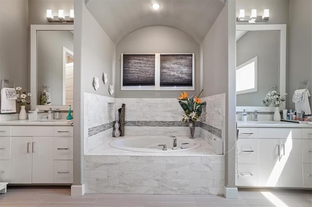8605 NE Shl Creek Pkwy, Kansas City, MO 64157 - full bathroom featuring two vanities, a bath, and vaulted ceiling