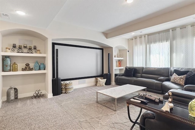 8605 NE Shl Creek Pkwy, Kansas City, MO 64157 - carpeted cinema featuring built in shelves, baseboards, arched walkways, and recessed lighting