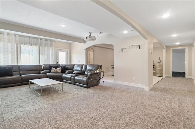 8605 NE Shl Creek Pkwy, Kansas City, MO 64157 - carpeted living room with arched walkways, baseboards, and recessed lighting